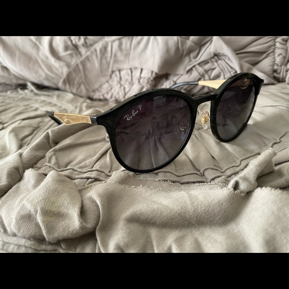 Black Ray-Ban sunglasses with gold accents